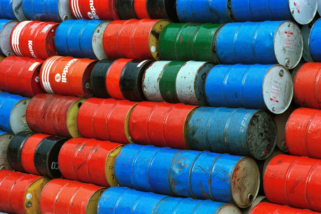 Vibrant stack of colorful industrial barrels, ideal for environmental or industrial themed projects.